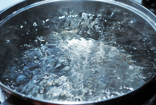A pot of boiling water close up.